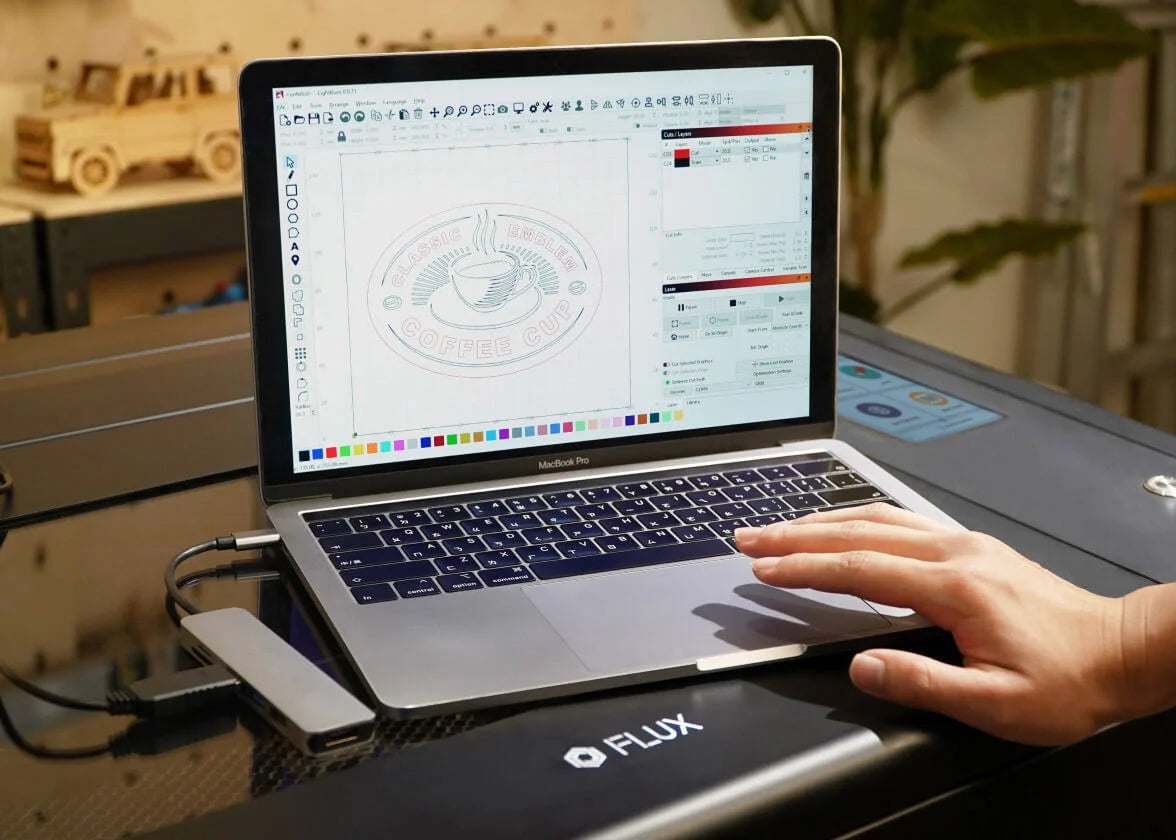FLUX BeamBox Pro 50W CO2 Laser Cutter & Engraver connected to laptop