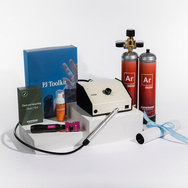 Zapp Welder PJ Toolkit with various items including a blue book, red canisters, and a white device on a white background.